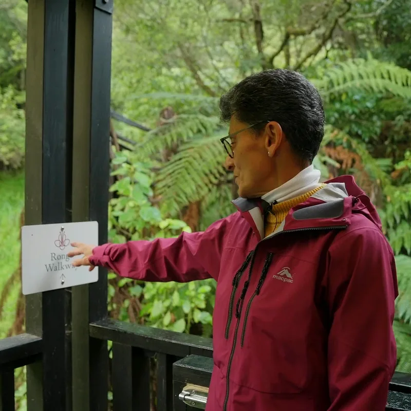 Damon on the deck, pointing out the Rongo Walkway sign at the start of the track